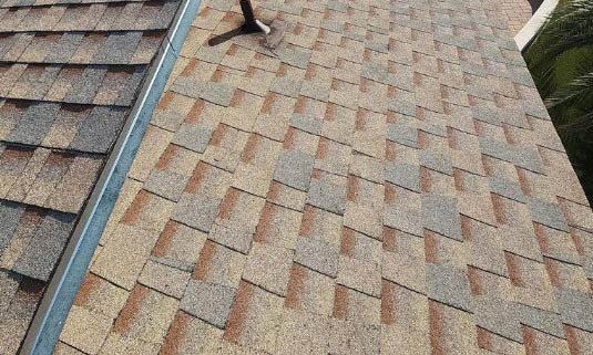 Newly installed asphalt shingle roof showcasing durable materials and expert workmanship, emphasizing energy efficiency and quality, integral to Ironclad Roofing's services.