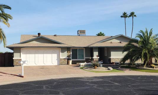 Residential home with a durable roof, showcasing a modern design and landscaping, reflecting Ironclad Roofing's commitment to quality and aesthetic appeal in Arizona roofing projects.