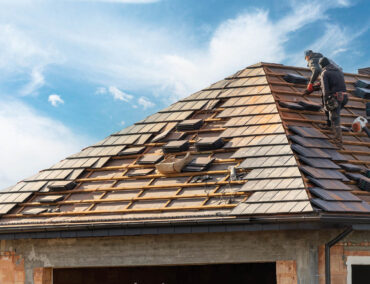Roofing contractor replacing shingles on a residential roof in Anthem, AZ, showcasing roofing expertise and craftsmanship for local homeowners.