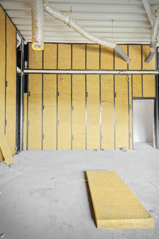 Interior view of a garage with installed rigid foam board insulation on walls, showcasing moisture-resistant materials for enhanced energy efficiency and temperature control in Arizona's climate.