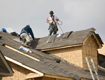 Roofing contractors installing asphalt shingles on a residential roof in Gilbert, AZ, showcasing expert craftsmanship and attention to detail.