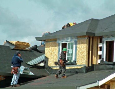Roofing contractors working on a residential roof installation in Prescott, showcasing expertise in roof replacement and durable materials suited for Northern Arizona's climate.
