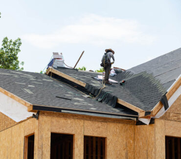 Roofing contractor working on asphalt shingle installation on a Scottsdale home, showcasing quality craftsmanship and attention to detail.