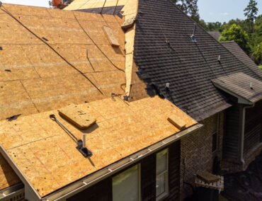 Roofing project in progress, featuring exposed underlayment and shingles on a residential home, highlighting roof replacement services tailored for Tucson's climate challenges.